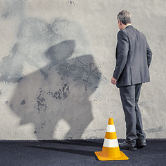 Image showing a business man facing a dirty wall