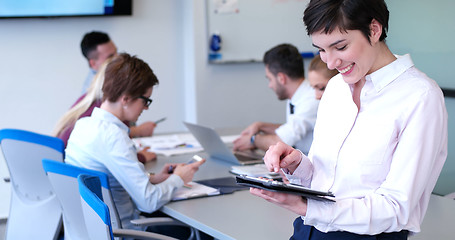 Image showing Portrait of  smiling casual businesswoman using tablet  with cow