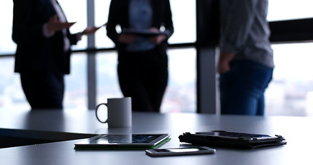 Image showing tablet, mobile cell phone and cup of coffee  in office with busi