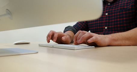 Image showing hands typing on computer keyboard in startup office