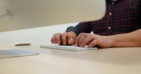 Image showing hands typing on computer keyboard in startup office