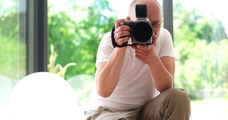 Image showing Photographer takes pictures with DSLR camera