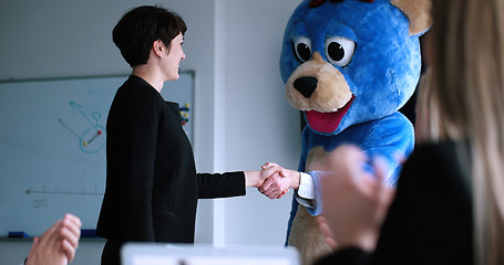 Image showing boss dresed as bear having fun with business people in trendy of