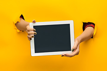 Image showing female teen hands using tablet pc with black screen, isolated