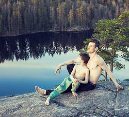 Image showing middle age man with little cute son doing sport yoga on the top of the mountain together, happy family lifestyle people outdoor, summer wild nature for training 