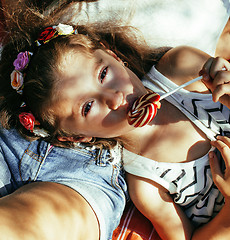 Image showing cute happy family on picnic laying on green grass mother and kids, warm summer vacations