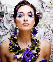 Image showing floral face art with anemone in jewelry, sensual young brunette woman