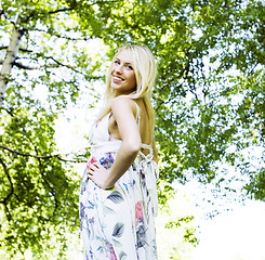 Image showing happy blond young woman in park smiling