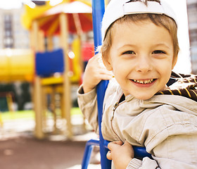 Image showing little cute boy on swing outside