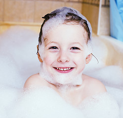 Image showing little cute boy in bathroom with bubbles close up