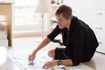 Image showing fashion designer with cloth making dress at studio