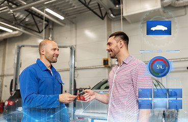 Image showing auto mechanic giving key to man at car shop