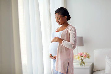 Image showing pregnant african american woman at home window