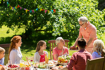 Image showing happy family having dinner or summer garden party