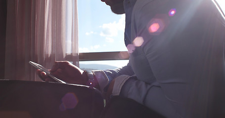 Image showing Business Man Talking On Cell Phone At Home