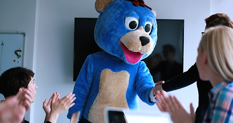 Image showing boss dresed as bear having fun with business people in trendy of