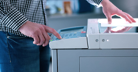 Image showing Male Assistant Using Copy Machine in modern office