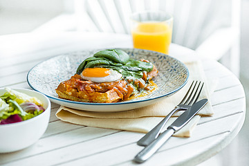 Image showing Scrambled eggs on meat with fried potatoes and toast