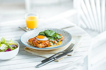 Image showing Scrambled eggs on meat with fried potatoes and toast