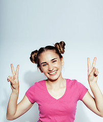 Image showing young pretty teenage hipster girl posing emotional happy smiling on white background, lifestyle people concept 