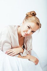 Image showing young pretty woman happy smiling, laying in bed, lifestyle people concept