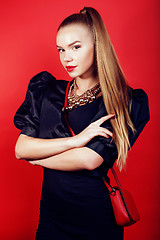 Image showing young pretty woman young lady posing on red background, lifestyle people concept