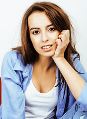 Image showing young pretty teenage hipster girl posing emotional happy smiling on white background, lifestyle people concept 