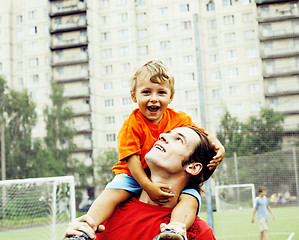 Image showing outdoor lifestyle people concept, happy family: father and son playing football together