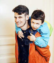 Image showing young handsome father with his son fooling around at home, lifes