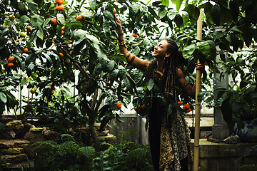 Image showing Young cute smiling woman in park with oranges