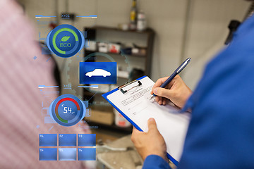 Image showing auto mechanic with clipboard and man at car shop