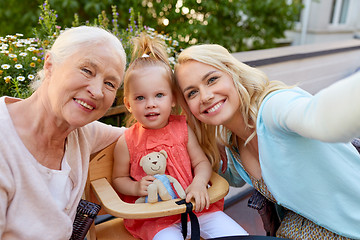 Image showing happy family taking selfie at cafe