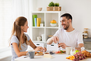 Image showing happy couple having breakfast at home