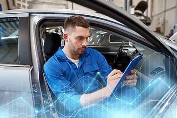 Image showing auto mechanic man with clipboard at car workshop