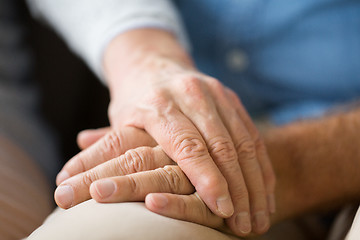 Image showing close up of senior couple holding hands