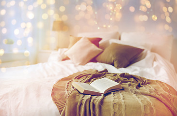 Image showing bedroom with bed and christmas garland at home