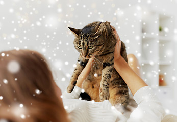 Image showing young woman with cat lying in bed at home