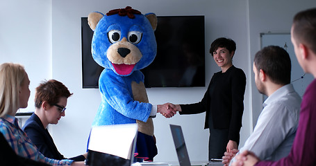 Image showing boss dresed as bear having fun with business people in trendy of