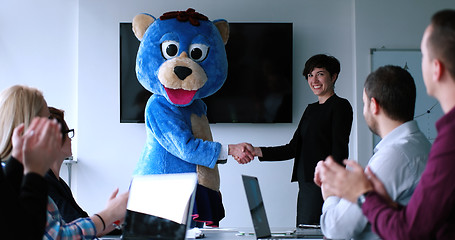 Image showing boss dresed as bear having fun with business people in trendy of