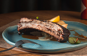 Image showing grilled pork ribs on dark plate