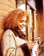 Image showing young pretty african american women drinking coffee outside in c