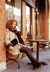 Image showing young pretty african american women drinking coffee outside in c