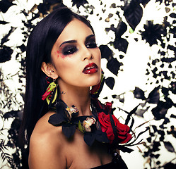 Image showing pretty brunette woman with rose jewelry, black and red, bright m