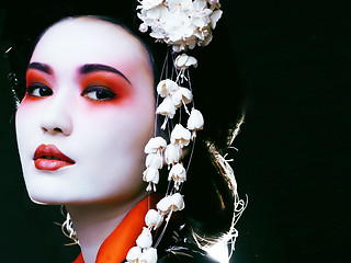 Image showing geisha in kimono on black