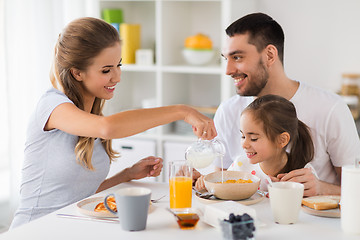 Image showing happy family having breakfast at home