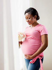 Image showing happy african american pregnant woman with flowers