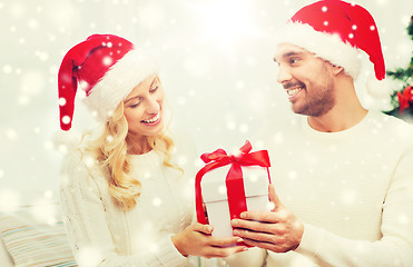 Image showing happy couple at home with christmas gift box