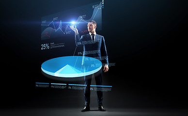 Image showing businessman in suit working with virtual pie chart