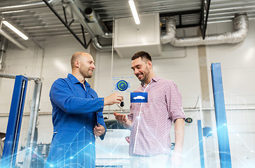 Image showing auto mechanic giving key to man at car shop