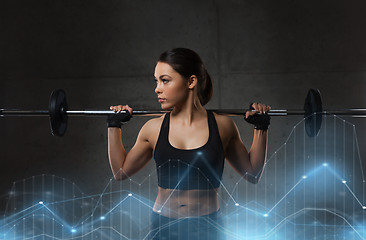 Image showing young woman flexing muscles with barbell in gym